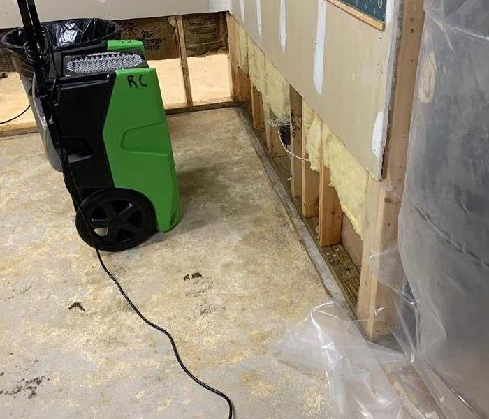 Flood cut in a wall and dehumidifier machine 